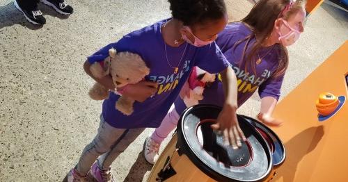 Young students playing drums on a field trip